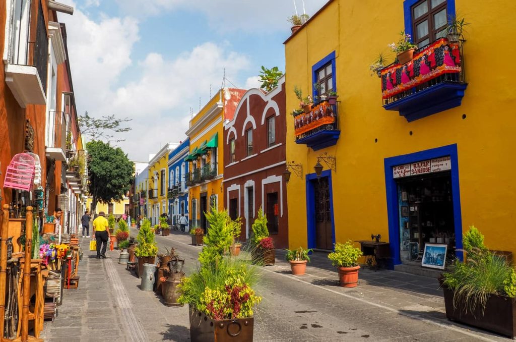 Colorful colonial buildings line the vibrant Callejón de los Sapos in Puebla, one of the best cities in Mexico.