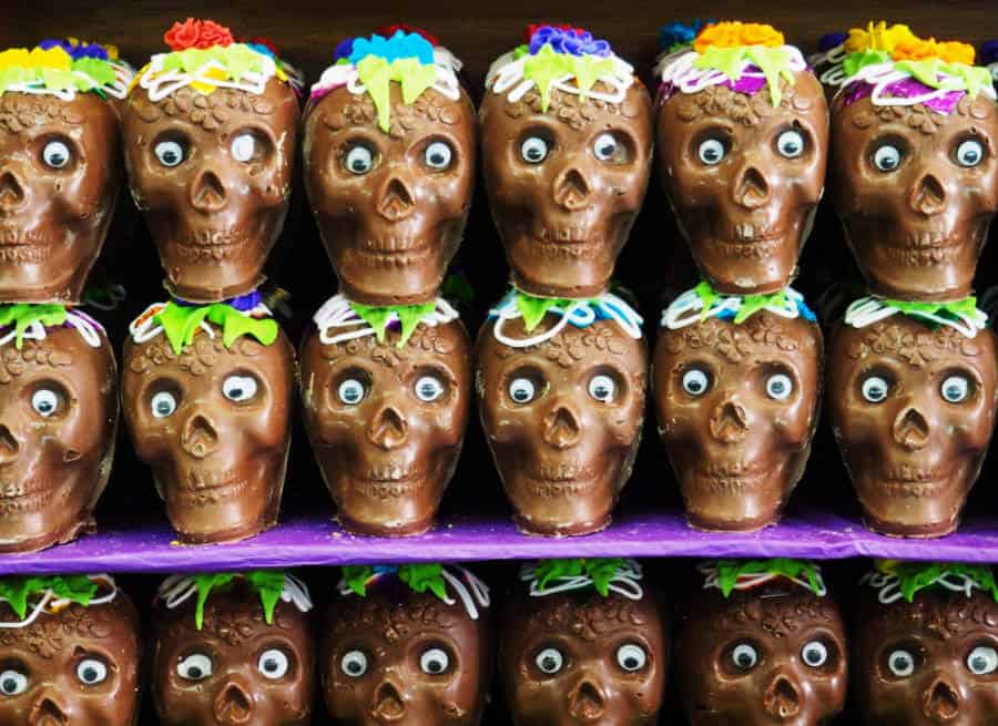 Chocolate Day of the Dead skulls line the shelf at a candy store.