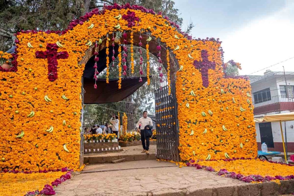 Entrance of a cemetery decorated entirely in yellow and some red flowers on the Day of the Dead in Michoacan.