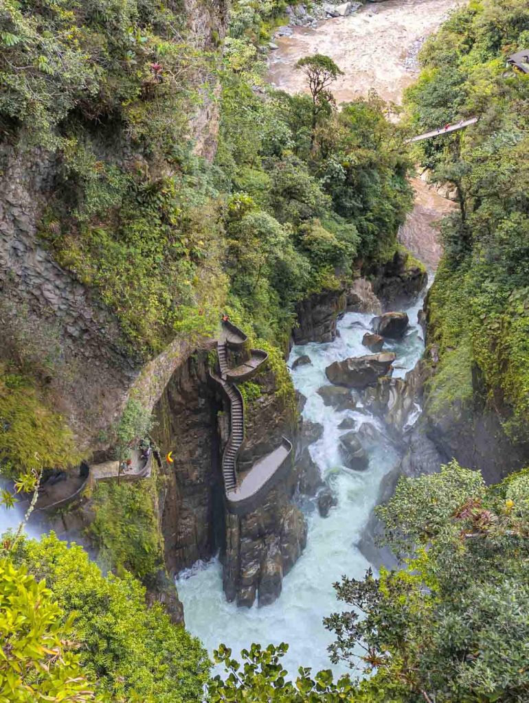 Aerial view of the Devil's Cauldron waterfall crashing into a gorge below, with a twisting path and observation decks hugging the cliffside.