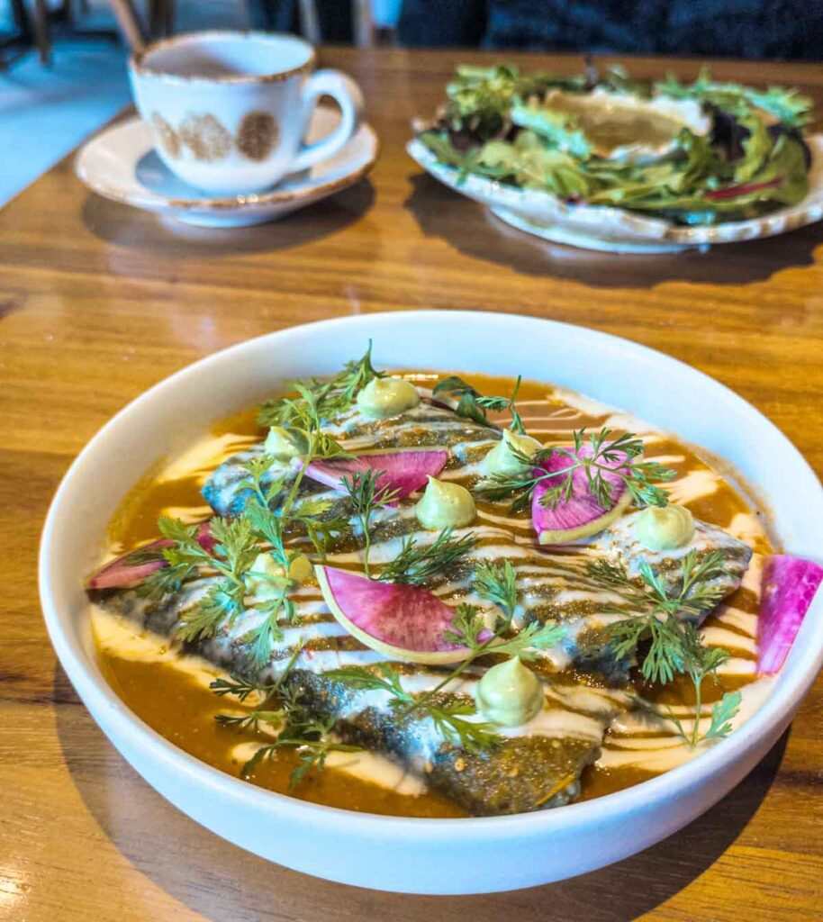 One of the best brunch in Mexico City is this plate of enchiladas bathed in a red sauce and topped with strawberry radish and crema.