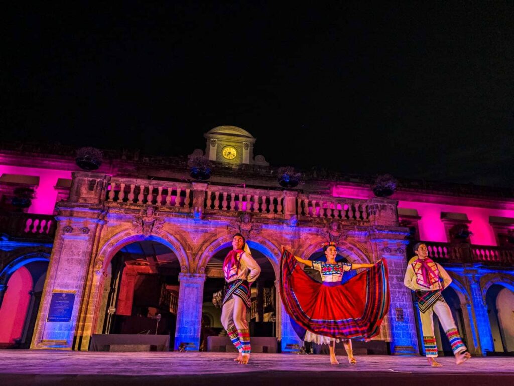 Two men and a woman dancers dressed in traditional clothing perform during the Folkloric Ballet at Chapultepec Castle in Mexico CIty.