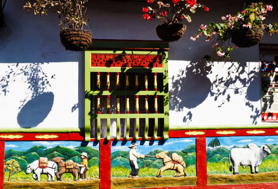 A colorful zocalo depicts a farmer pulling his mules with cargo in three panels.