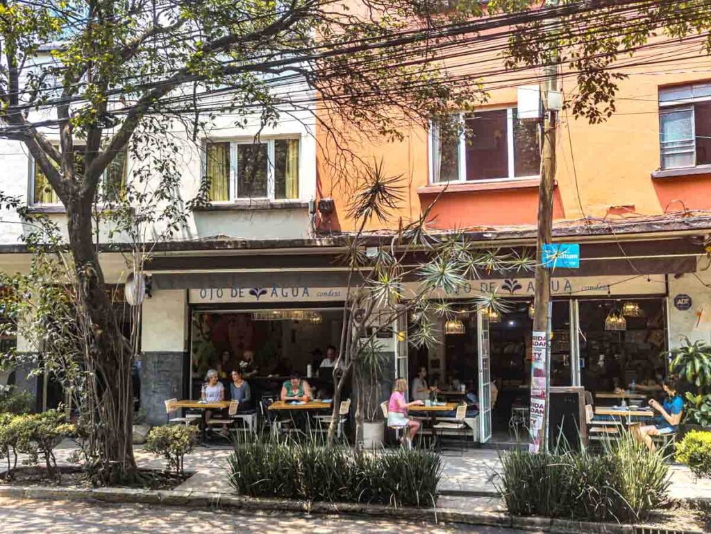 Diners sit at tables outside of Ojo de Agua Restaurant during breakfast in Mexico City.