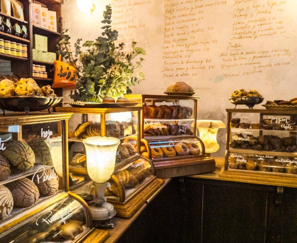 Bread and pastries in small glass displays at the Rosetta Bakery in Mexico City.