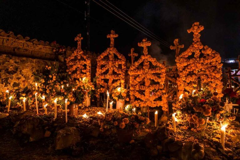 Flowers and candles decorate a gravesite for Dia De Muertos in Patzcuaro.