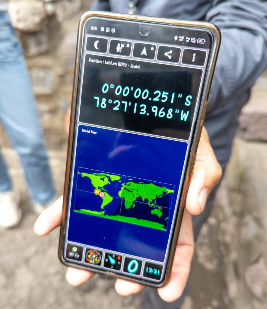 Smartphone screen showing exact GPS coordinates at the equator in Ecuador, highlighting the scientifically significant location of the Intiñan Museum near Mitad del Mundo Ecuador.