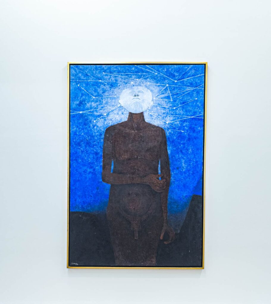 An artwork in the Rufino Tamayo Museum in Mexico City depicts a naked man looking up to the sky surrounded by geometric patterns.