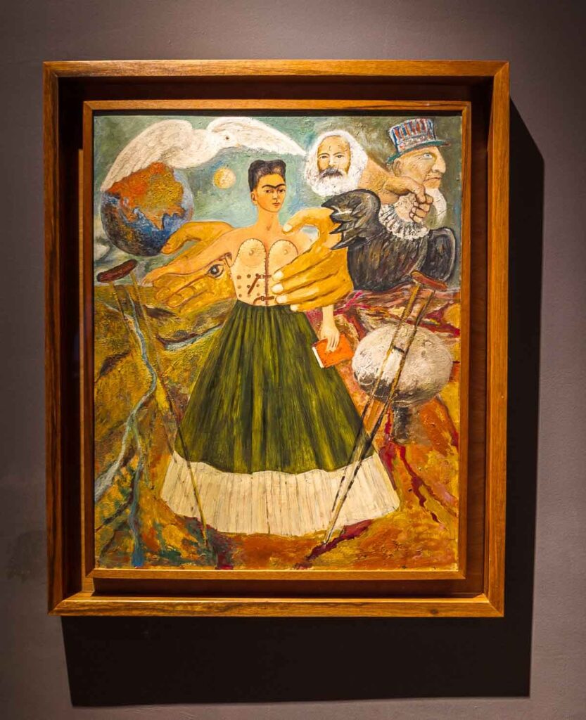 A self-portrait of Frida Kahlo displayed in a museum. Kahlo's face is depicted with bold colors and intricate details, expressing her unique style and emotions.