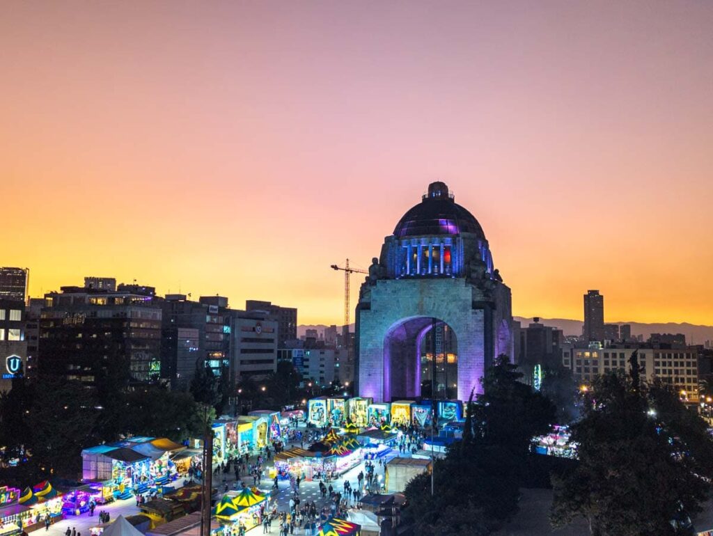 A view of The Revolution Monument at sunset from Terraza Cha Cha Cha, one of the best rooftops in Mexico City.