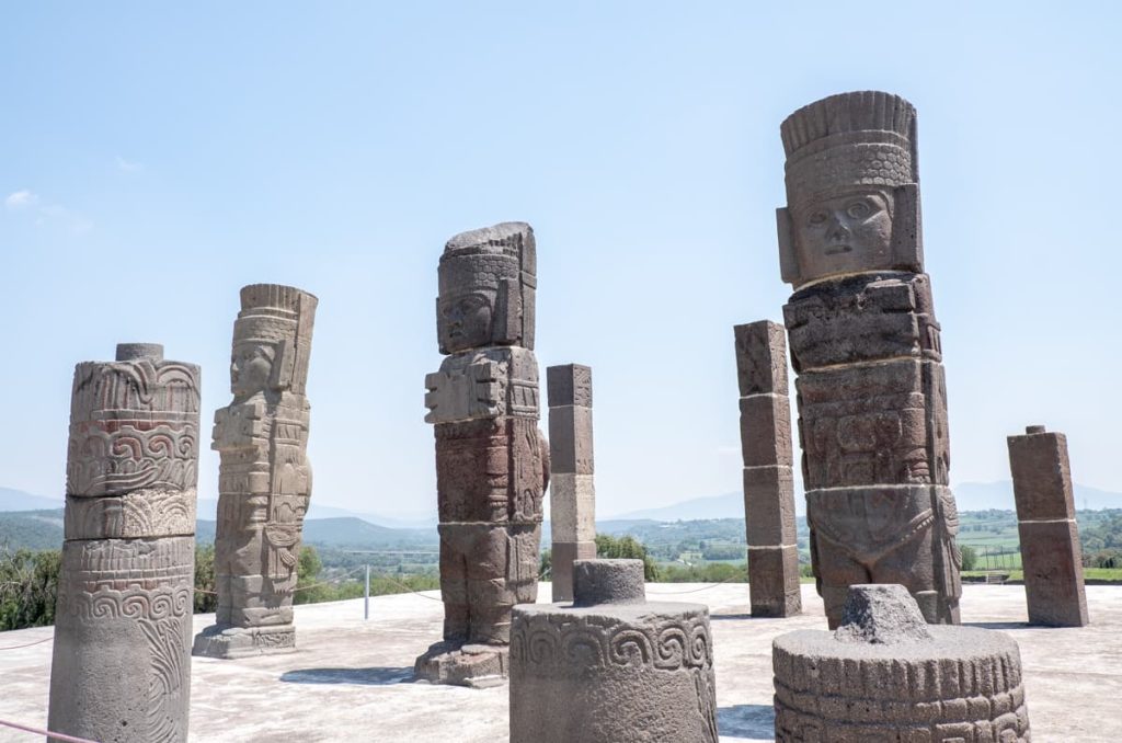Massive Toltec warrior statues known as Atlantes stand at the ancient archaeological site of Tula in Hidalgo, a great day trip from Mexico City.