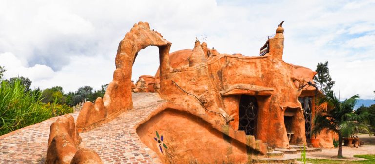 A ramp leads up the back of Casa Terracota with a decorative clay crocodile form through the middle that leads to an arch.