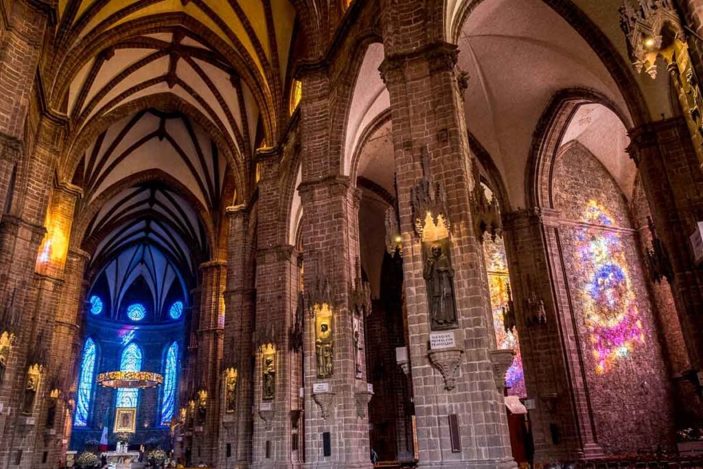 Interior of church Zamora in Michoacan, depicting different statues at the walls.